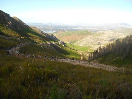 A long line of riders stretches through the mountains